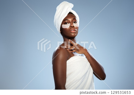 Beauty treatment with face mask and spa towel as part of self-care routine in a relaxing atmosphere 129531653