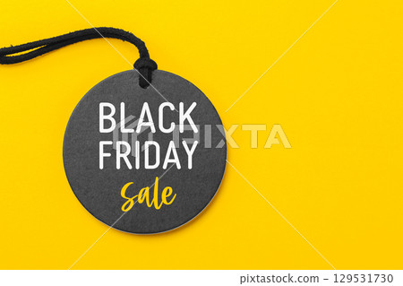 Black friday sale on black price tag on yellow background 129531730