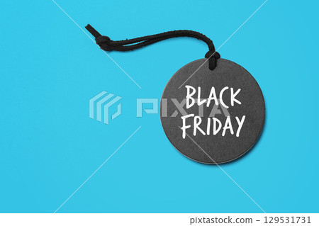 Black friday word on black sale tag on blue background 129531731