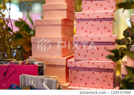 Display of decorative gift boxes arranged in a retail setting during the holiday season Display of decorative gift boxes arranged in a retail setting during the holiday season 129531900