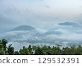 The city and mountains are covered in fog. 129532391
