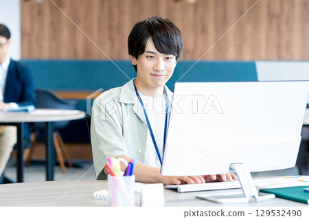A young businessman working in the office A young businessman working in the office 129532490