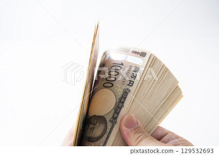 Holding a stack of bills, counting bills 129532693