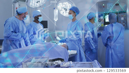 Image of dna strand over diverse surgeons during surgery 129533569