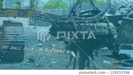 Hoisting electromagnet lifter raising corroded engine block over scrap yard, with heavy chains Hoisting electromagnet lifter raising corroded engine block over scrap yard, with heavy chains 129533596