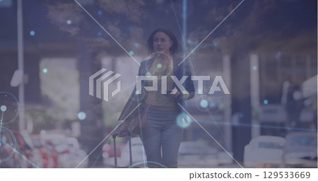 Network of connections over caucasian businesswoman with trolley bag walking on the street Network of connections over caucasian businesswoman with trolley bag walking on the street 129533669