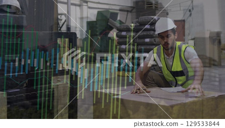 Image of male warehouse worker over graphs Image of male warehouse worker over graphs 129533844