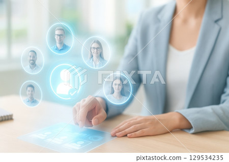 Businesswoman using virtual interface to manage team members and select candidates 129534235