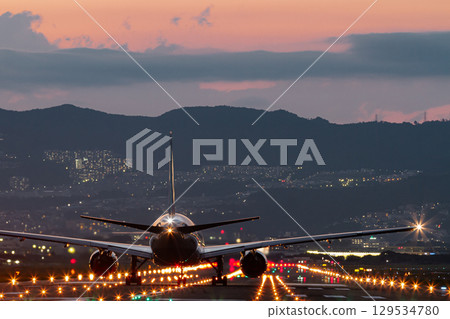 Runway and planes during magic hour 129534780