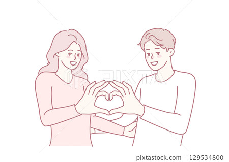 Happy couple show heart hand gesture 129534800