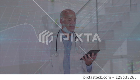 Image of data processing over caucasian male doctor with tablet Image of data processing over caucasian male doctor with tablet 129535263