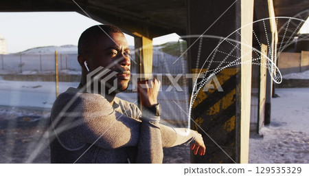 Image of dna strand over african american man stretching Image of dna strand over african american man stretching 129535329