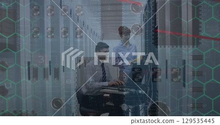 Microprocessor connections over caucasian male and female engineers working at server room Microprocessor connections over caucasian male and female engineers working at server room 129535445