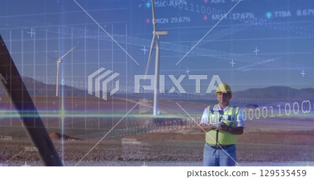 Stock market data processing and binary coding over male engineer flying drone near wind turbines 129535459