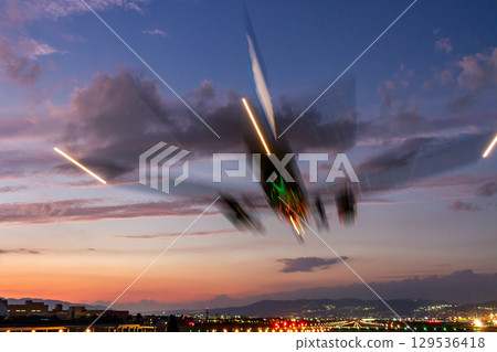 Abstract light trail of a landing plane 129536418