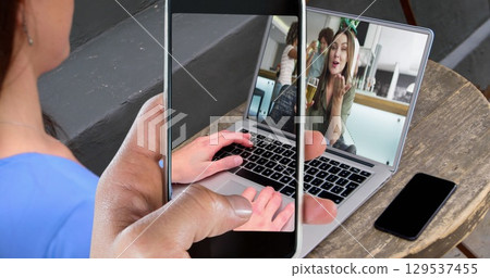 Image of online marketing text and icons over caucasian woman using laptop Image of online marketing text and icons over caucasian woman using laptop 129537455