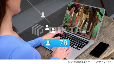 Image of social media icons with growing number over woman using laptop Image of social media icons with growing number over woman using laptop 129537456