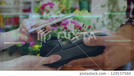 Image of financial data over hands of diverse people using payment terminal 129537560