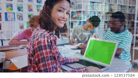 Image of graph over happy girl using laptop with copy space at school 129537584