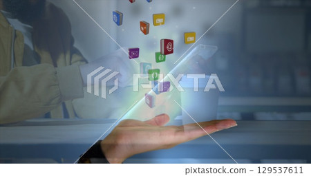 Image of falling social media icons over women using tablet Image of falling social media icons over women using tablet 129537611