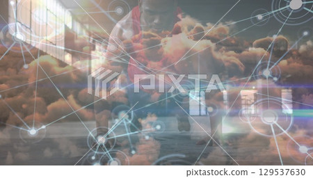 Network of digital icons over clouds in the sky against african american fit man performing push ups 129537630