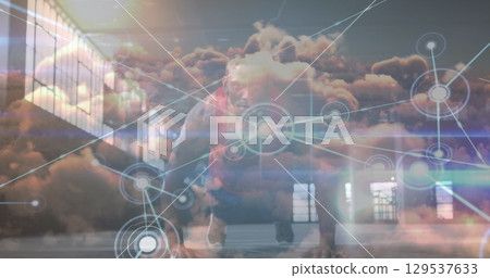 Image of network of connections and sky with clouds over african american man doing push-ups 129537633