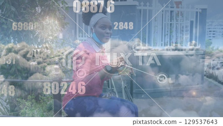Network of digital icons and clouds against african american woman having a snack on the street Network of digital icons and clouds against african american woman having a snack on the street 129537643