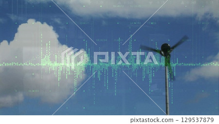 Image of graph and processing data over wind turbine against cloudy blue sky 129537879