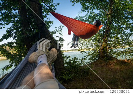 Relaxing in Hammocks by the Lake Relaxing in Hammocks by the Lake 129538051
