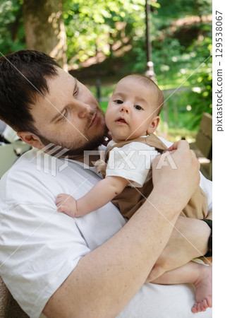 Father Holding Baby in Sunny Park Father Holding Baby in Sunny Park 129538067