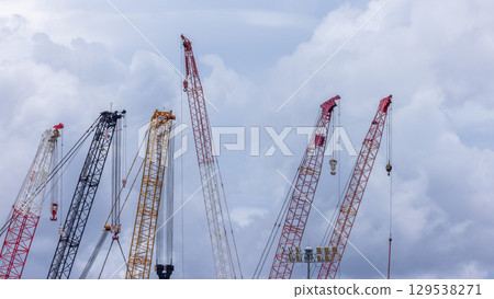 Crawler crane on blue sky white clouds background, Real estate industry. Red crawler crane use reel lift up equipment in construction site. Crane for rent. Crane dealership for construction business. 129538271