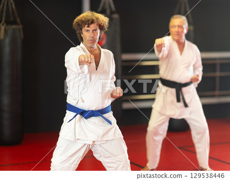 Man with other athletes of different ages during karate classes 129538446