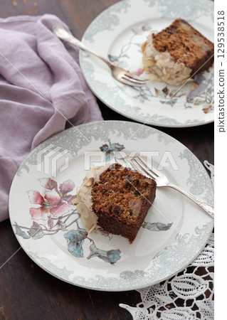 Carrot cake topped with almonds 129538518