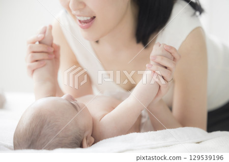 Young mother taking care of her baby 129539196