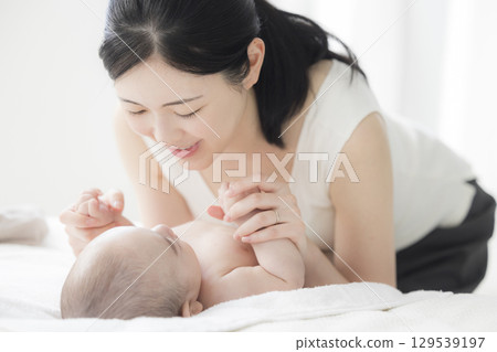 Young mother taking care of her baby Young mother taking care of her baby 129539197