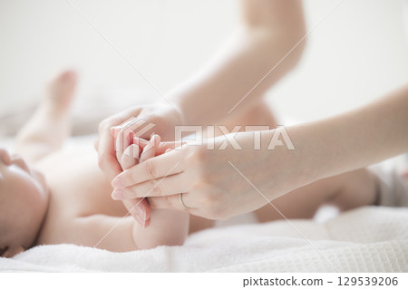 Young mother taking care of her baby 129539206