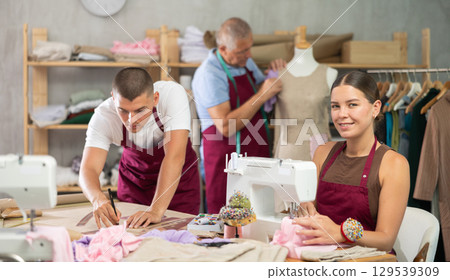 Girl employee sewing, stitch clothes, mature man work with mannequin, guy draw dress pattern Girl employee sewing, stitch clothes, mature man work with mannequin, guy draw dress pattern 129539309