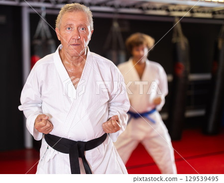 Man with other athletes of different ages during karate classes Man with other athletes of different ages during karate classes 129539495