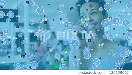 Image of data processing over african american businesswoman using smartphone in office 129539602