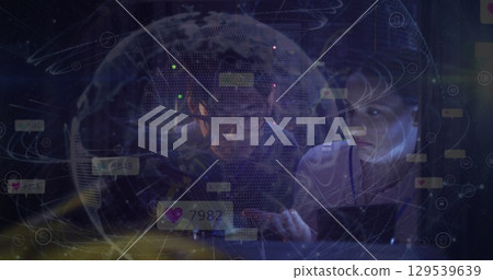 Image of globe and icons over diverse couple of server room workers 129539639
