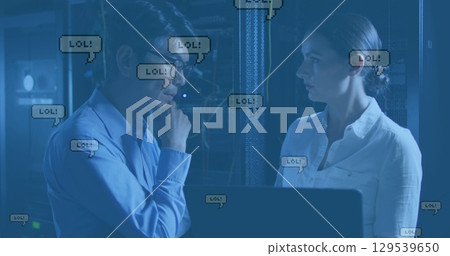Image of lol texts falling over diverse couple of server room workers Image of lol texts falling over diverse couple of server room workers 129539650