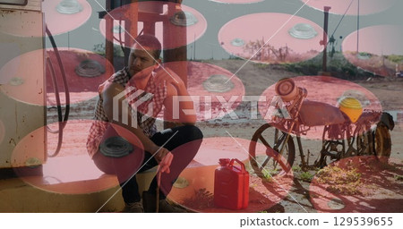 Image of barrels over caucasian man at petrol station Image of barrels over caucasian man at petrol station 129539655