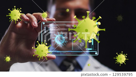 Image of falling covid 19 cells over man using tablet 129539795