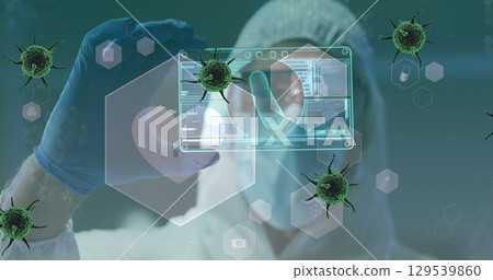 Image of green virus cells over caucasian male lab worker in safety clothes with digital card Image of green virus cells over caucasian male lab worker in safety clothes with digital card 129539860
