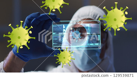 Image of yellow virus cells over caucasian male lab worker in safety clothes with digital card 129539871