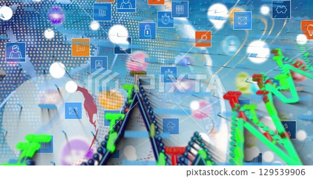 Image of globe, graphs and tech icons over blue background 129539906