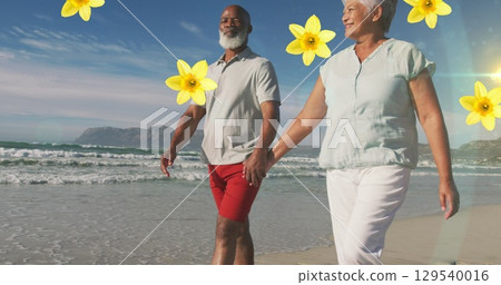 Image of falling flowers over caucasian senior couple on the beach 129540016