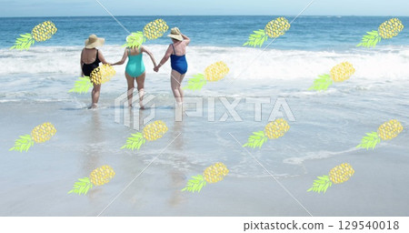 Image of falling pineapples over caucasian senior group of woman on the beach Image of falling pineapples over caucasian senior group of woman on the beach 129540018
