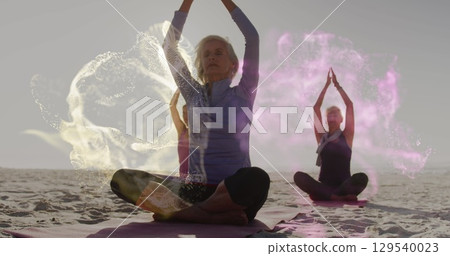 Image of falling icons over group of caucasian women practicing yoga Image of falling icons over group of caucasian women practicing yoga 129540023