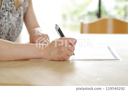 A woman signing a contract 129540292